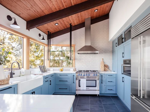 Inside a Dream: How Unexpected Blue Cabinets Elevate a Kitchen with Storage and Stunning Vistas